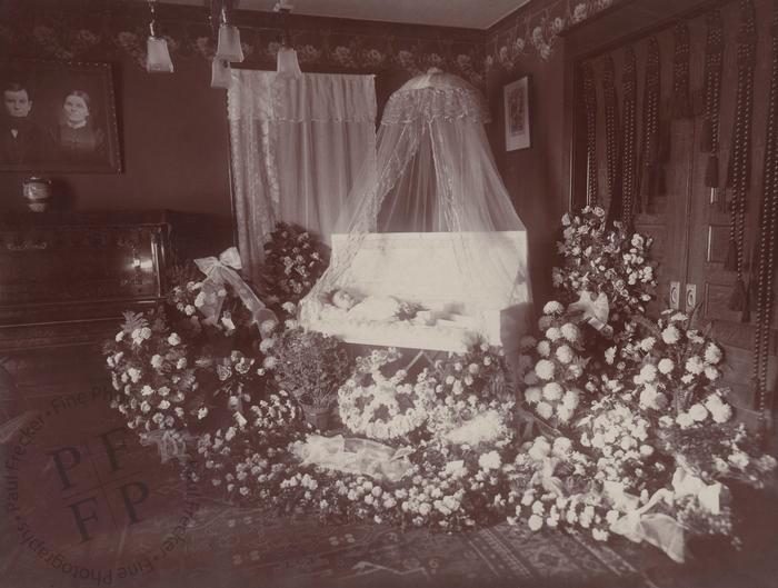 Child laid out under a white canopy