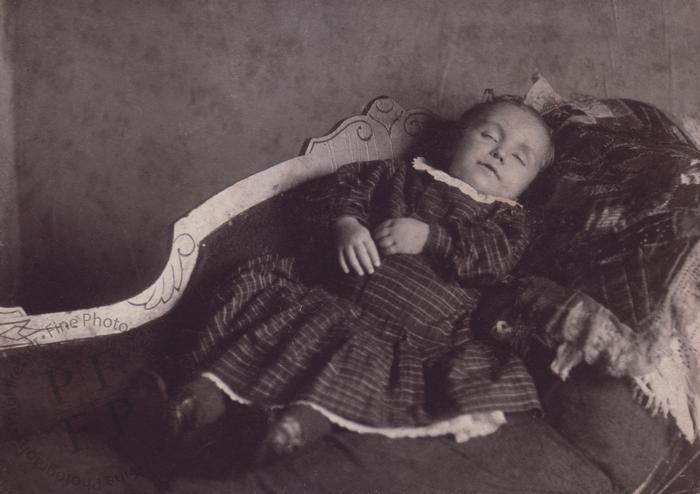 Infant laid out on a sofa