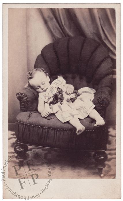 Bare-footed child on an armchair