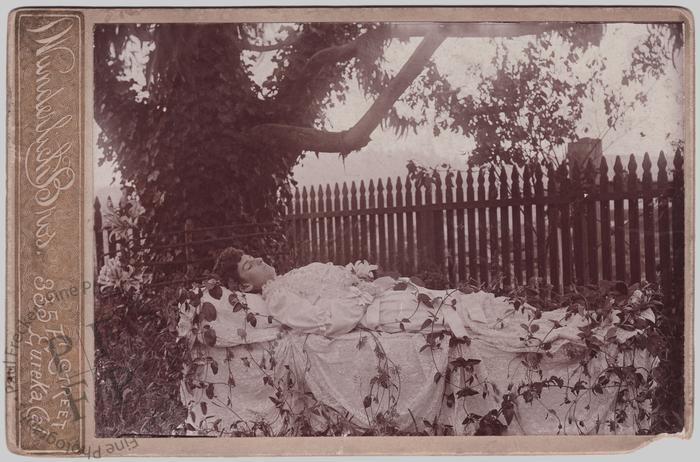 Woman by a picket fence