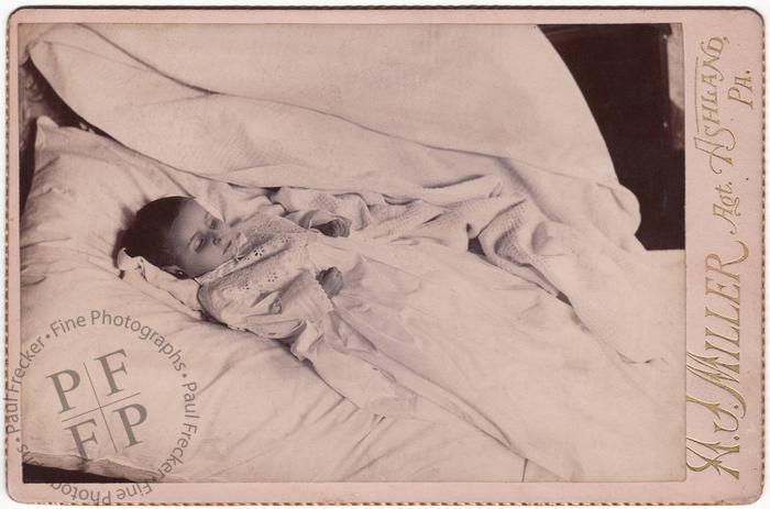 Infant in a christening gown