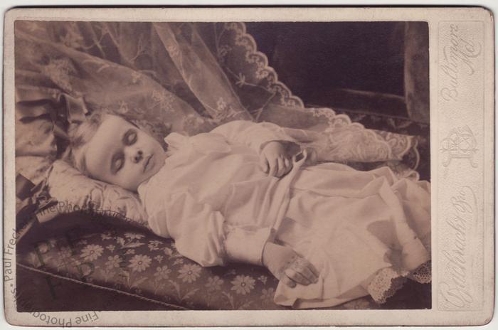 Child on cushions and a sofa