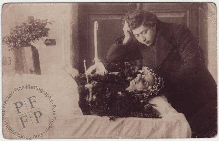 Widower contemplating the face of his wife