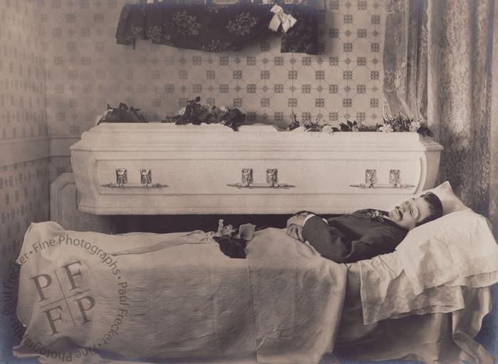 Man next to a white casket