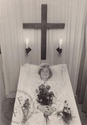 Elderly woman in an open coffin