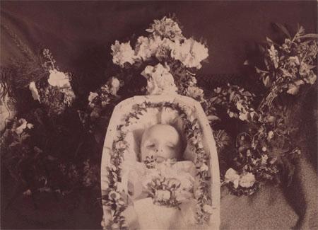 Baby in a coffin with flowers