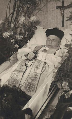 Priest in an open coffin
