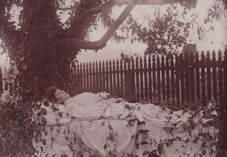 Woman by a picket fence