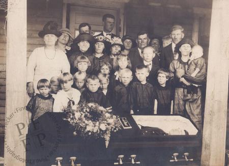Mourners on a wooden porch 