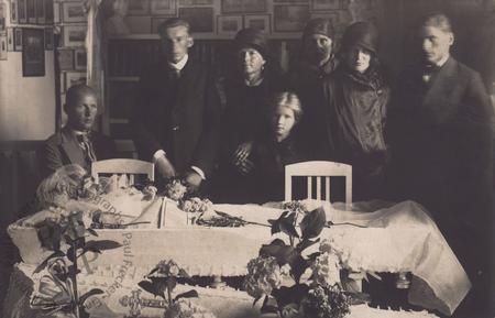 Mourners beside an open coffin II