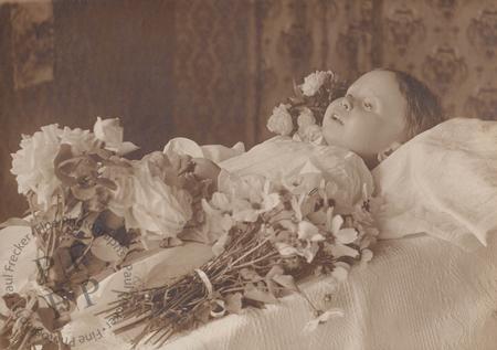 Waxen-faced child with flowers