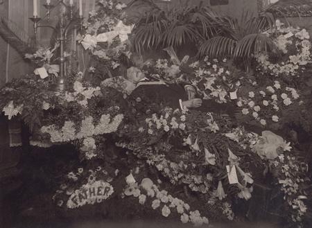 Father surrounded with floral tributes