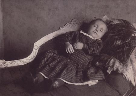Infant laid out on a sofa