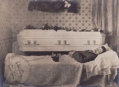 Man next to a white casket